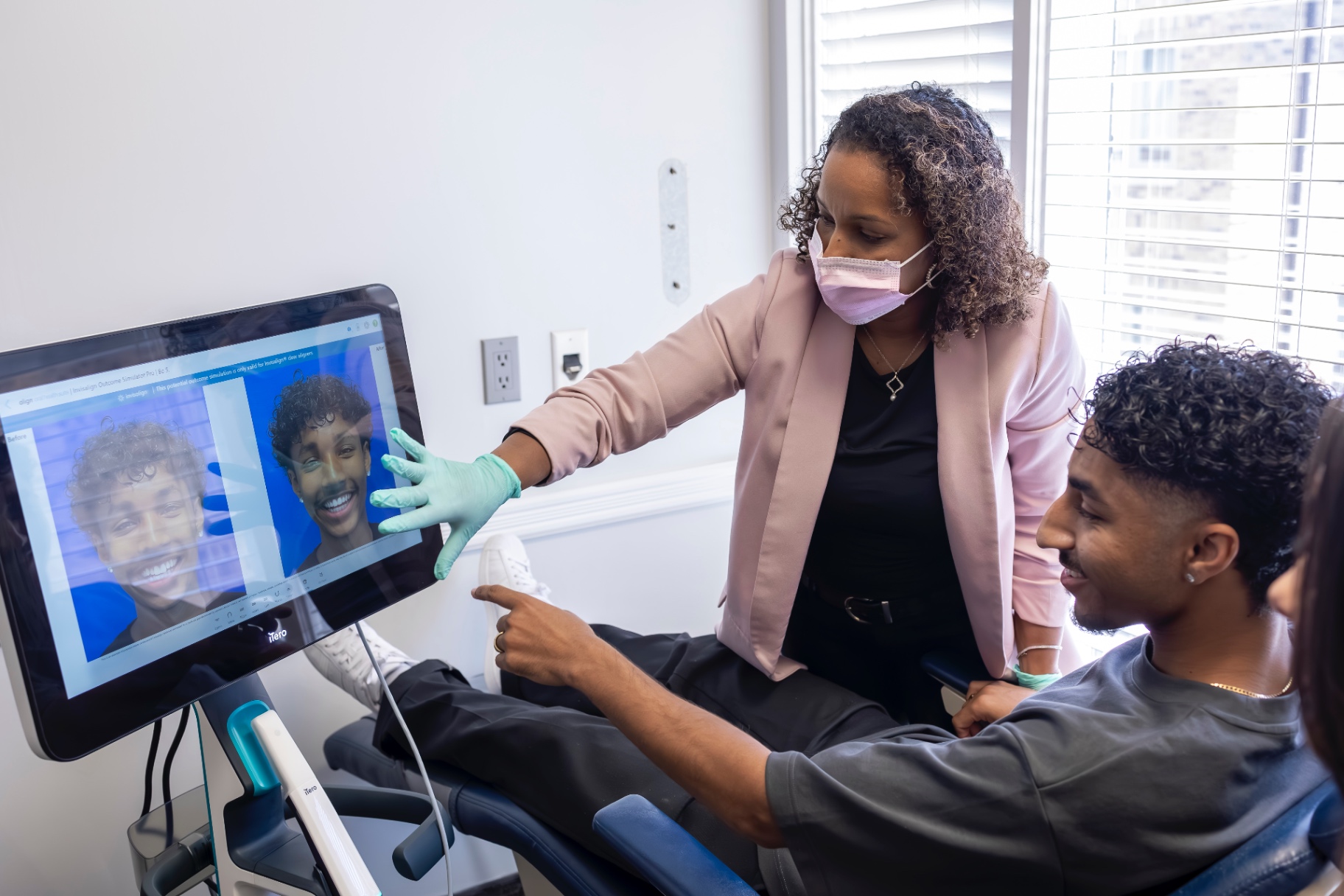 Debbie reviewing an iTero outcome simulation with a patient