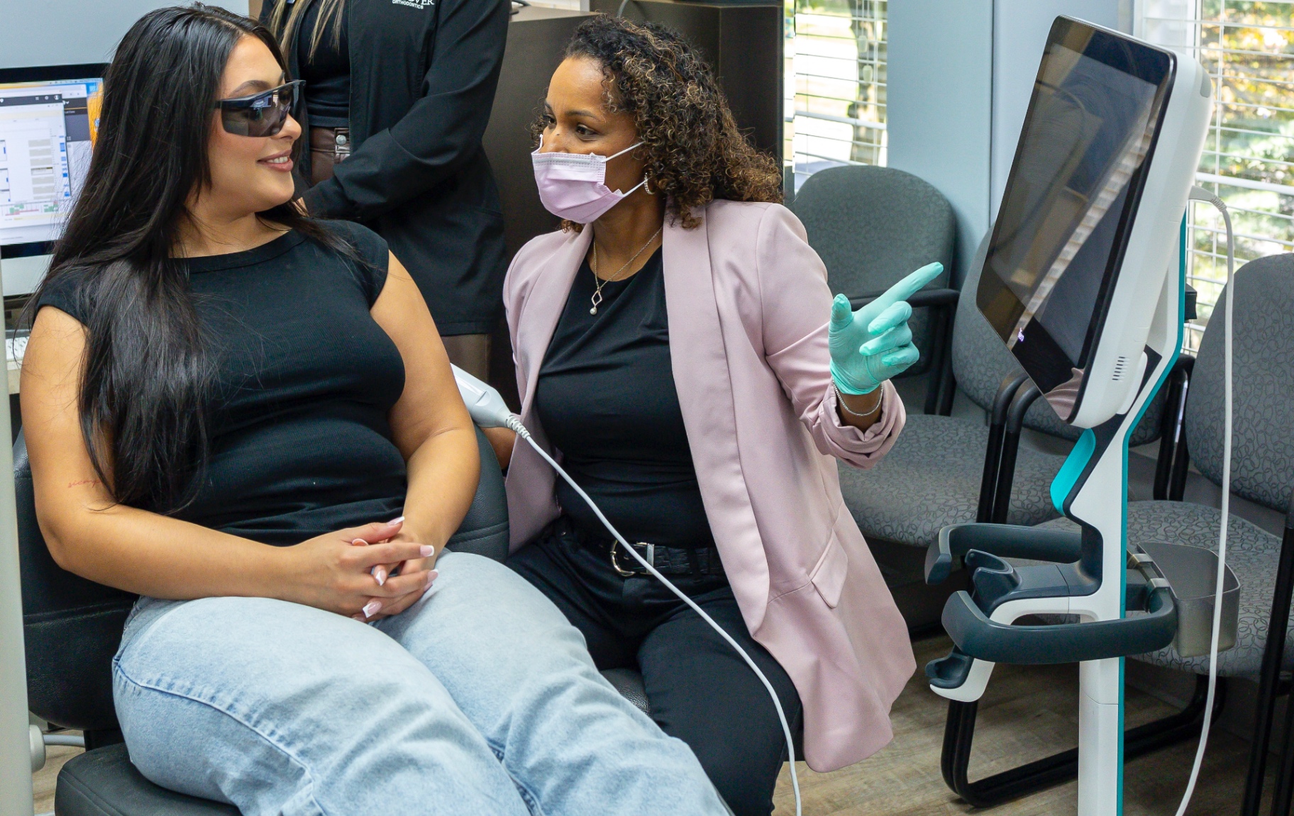 Debbie guiding a patient through an iTero digital scan during a chairside consultation.